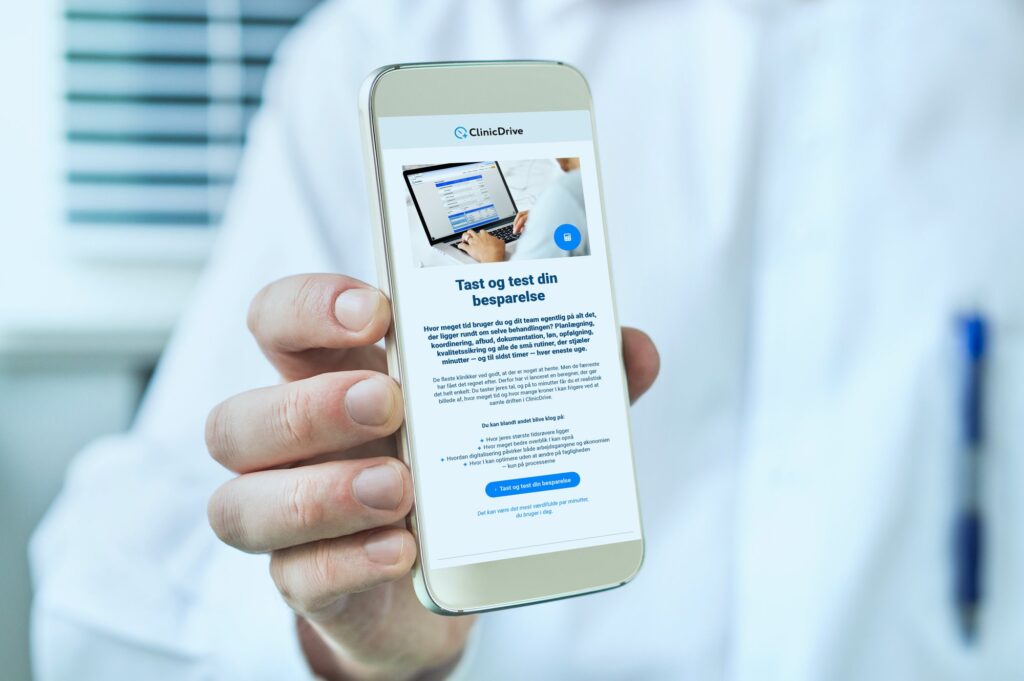 Doctor holding smartphone with empty blank white screen. Medical professional, physician, nurse or dentist showing mobile phone with copy space.